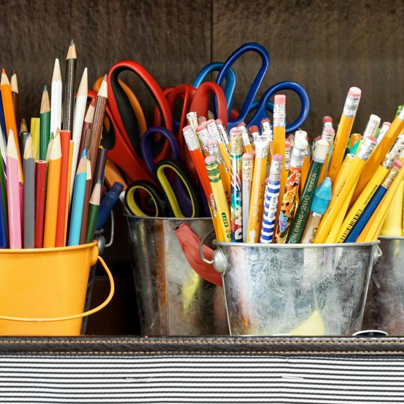 Pencils and scissors in small buckets